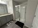 Clean bathroom with a glass-enclosed shower, granite countertop, and gray wood floor at 7621 Gray Pointe Dr, Lithonia, GA 30058