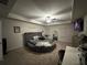Relaxing bedroom with a circle bed, ceiling fan, mounted tv and cozy carpet at 7621 Gray Pointe Dr, Lithonia, GA 30058
