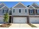 Charming townhome showcasing a brick front, complemented by a two-car garage and well-manicured landscaping at 7621 Gray Pointe Dr, Lithonia, GA 30058