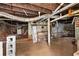 Basement features exposed plumbing, brick foundation, and concrete flooring at 1377 Pine Ave, Atlanta, GA 30344