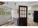 Bathroom and kitchen combination features a toilet, sink, and black refrigerator at 1377 Pine Ave, Atlanta, GA 30344