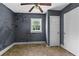 Bedroom features gray painted walls, window, linoleum flooring and white door at 1377 Pine Ave, Atlanta, GA 30344
