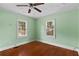 Light-filled bedroom features hardwood floors, two windows, and a ceiling fan at 1377 Pine Ave, Atlanta, GA 30344
