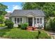 Charming home featuring gray shutters, landscaped bushes, and a cozy front porch at 1377 Pine Ave, Atlanta, GA 30344