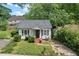 Charming home featuring gray shutters, landscaped bushes, and a cozy front porch at 1377 Pine Ave, Atlanta, GA 30344