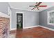 View of the living room featuring hardwood floors, brick fireplace, and natural light at 1377 Pine Ave, Atlanta, GA 30344