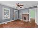 View of the living room featuring hardwood floors, brick fireplace, and natural light at 1377 Pine Ave, Atlanta, GA 30344