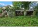 Old shed with weathered wood and overgrown vines surrounded by lush foliage at 1377 Pine Ave, Atlanta, GA 30344