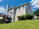 Charming two-story home featuring a deck, chimney, and lush green lawn at 479 Rising Sun Path, Lawrenceville, GA 30043