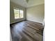 A stylish bedroom showcases natural light and gorgeous flooring at 479 Rising Sun Path, Lawrenceville, GA 30043