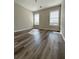 A cozy bedroom is brightened by two windows and enhanced by modern flooring at 479 Rising Sun Path, Lawrenceville, GA 30043