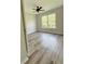 This cozy bedroom offers natural light, a ceiling fan, and modern flooring at 479 Rising Sun Path, Lawrenceville, GA 30043