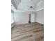 A primary bedroom features tray ceilings, modern fan, and gorgeous flooring at 479 Rising Sun Path, Lawrenceville, GA 30043