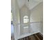 An open-concept foyer presents a stunning overhead light fixture and staircase at 479 Rising Sun Path, Lawrenceville, GA 30043
