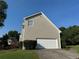 House showing an attached white garage door and driveway on a sunny day at 479 Rising Sun Path, Lawrenceville, GA 30043