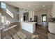 Modern kitchen view from the living area, featuring a white island, stainless appliances and beautiful cabinets at 479 Rising Sun Path, Lawrenceville, GA 30043