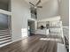 Bright open-concept living room features high ceilings, wood floors and seamless flow into modern kitchen with staircase at 479 Rising Sun Path, Lawrenceville, GA 30043