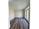 A naturally lit living room offers gorgeous flooring and access to the outdoor patio at 479 Rising Sun Path, Lawrenceville, GA 30043