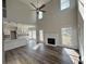 Bright living room with high ceilings, fireplace, wood floors and seamless flow into a modern, stylish kitchen at 479 Rising Sun Path, Lawrenceville, GA 30043
