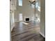 Bright living room featuring high ceilings, fireplace, wood floors, seamless flow into kitchen, and plenty of natural light at 479 Rising Sun Path, Lawrenceville, GA 30043