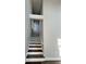 A beautiful staircase is enhanced by natural light and modern railings at 479 Rising Sun Path, Lawrenceville, GA 30043