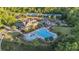 Aerial view of the community clubhouse and pool with play area, chairs and umbrellas for residents at 6150 Bridge Fair Rd, Cumming, GA 30028