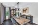 Elegant dining room with a rustic table, stylish decor, and natural light at 6150 Bridge Fair Rd, Cumming, GA 30028