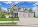 Charming home featuring a three-car garage, stone accents, shutters, and covered porch on a manicured lawn at 6150 Bridge Fair Rd, Cumming, GA 30028