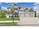 Beautiful two-story home with stone accents, a three-car garage, and manicured front yard at 6150 Bridge Fair Rd, Cumming, GA 30028