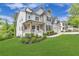 Charming home with a landscaped lawn, a covered porch, and stone and wood accents at 6150 Bridge Fair Rd, Cumming, GA 30028