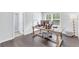 Home office with an oversized wooden desk, a window, hardwood floors, and an attached bathroom at 6150 Bridge Fair Rd, Cumming, GA 30028