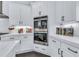 Sleek kitchen features white cabinetry, quartz countertops, stainless steel appliances, and modern hardware at 6150 Bridge Fair Rd, Cumming, GA 30028