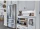 Modern kitchen featuring stainless steel appliances, white cabinetry, and a sleek countertop at 6150 Bridge Fair Rd, Cumming, GA 30028