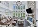 Open concept floor plan with stone fireplace, large windows, and dining area at 6150 Bridge Fair Rd, Cumming, GA 30028