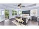 Spacious main bedroom with a tray ceiling, a ceiling fan, a private balcony, and hardwood floors at 6150 Bridge Fair Rd, Cumming, GA 30028