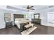 Spacious main bedroom featuring hardwood floors, tray ceiling, and a decorative ceiling fan at 6150 Bridge Fair Rd, Cumming, GA 30028