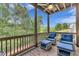 Inviting porch features comfortable seating and a peaceful view of the surrounding greenery at 6150 Bridge Fair Rd, Cumming, GA 30028