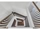 View of the home's staircase, featuring hardwood stairs and white decorative railings at 6150 Bridge Fair Rd, Cumming, GA 30028
