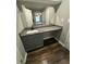 Bathroom vanity with granite countertop and wood-look floors at 123 Rue Fontaine, Lithonia, GA 30038