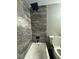 Bathroom featuring a shower with a gray tile surround and rainfall shower head at 123 Rue Fontaine, Lithonia, GA 30038