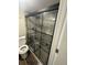 Bathroom featuring a glass enclosed shower with gray tile surround and rainfall shower head at 123 Rue Fontaine, Lithonia, GA 30038