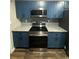 The kitchen features granite countertops, stainless appliances, and blue cabinets at 123 Rue Fontaine, Lithonia, GA 30038