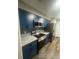 Stylish kitchen featuring stainless appliances, granite countertops, and attractive blue cabinetry at 123 Rue Fontaine, Lithonia, GA 30038