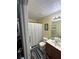 Bathroom featuring a shower with curtain, wood-look flooring, and single sink vanity at 2366 Bigwood Trl, Atlanta, GA 30349