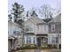 Traditional townhouse exterior featuring beige siding, multi-pane windows, and well-maintained landscaping at 2366 Bigwood Trl, Atlanta, GA 30349