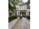 Inviting townhouse front entrance with stone accents, a decorative wreath, and a charming seating area at 2366 Bigwood Trl, Atlanta, GA 30349