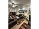 Cozy living room with leather furniture, ceiling fan, decorative mirrors, and a vibrant area rug at 2366 Bigwood Trl, Atlanta, GA 30349