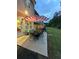 Outdoor patio featuring a dining set with umbrella and a well-maintained lawn at 2366 Bigwood Trl, Atlanta, GA 30349