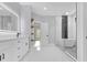 A modern bathroom featuring a soaking tub, glass shower and white cabinets at 3312 Mill Forest Dr, Conyers, GA 30094