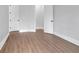 A bright bedroom featuring neutral walls and wood-look floors at 3312 Mill Forest Dr, Conyers, GA 30094